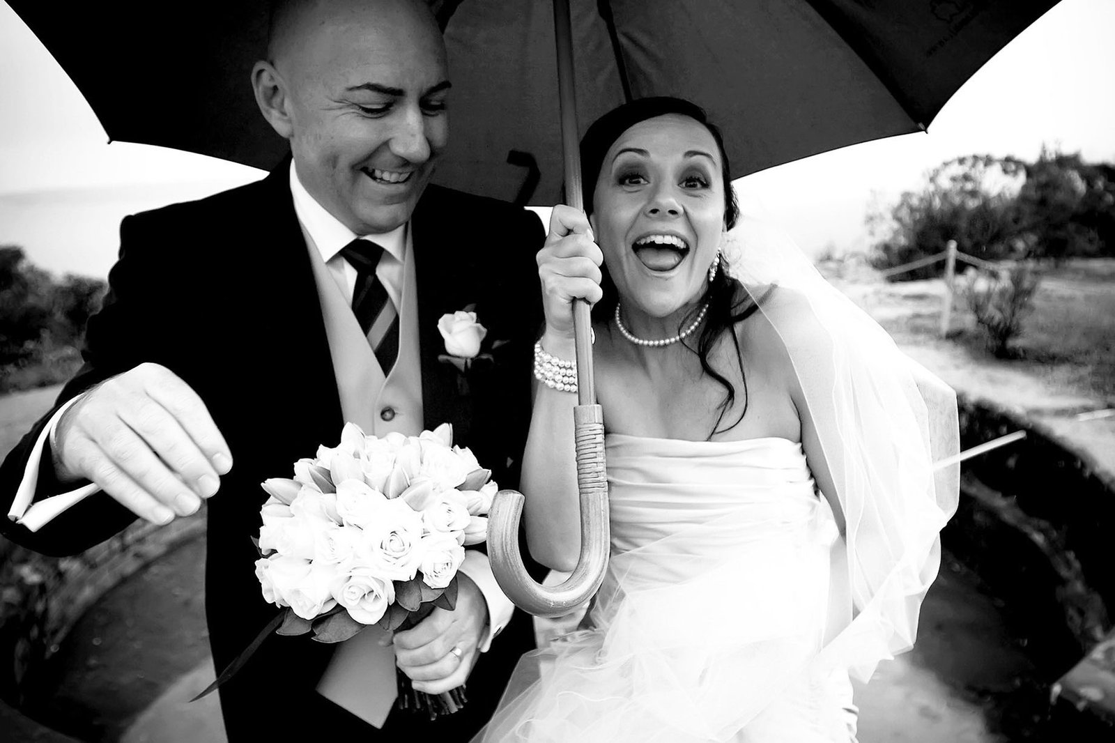 Bride groom wet wedding umbrella