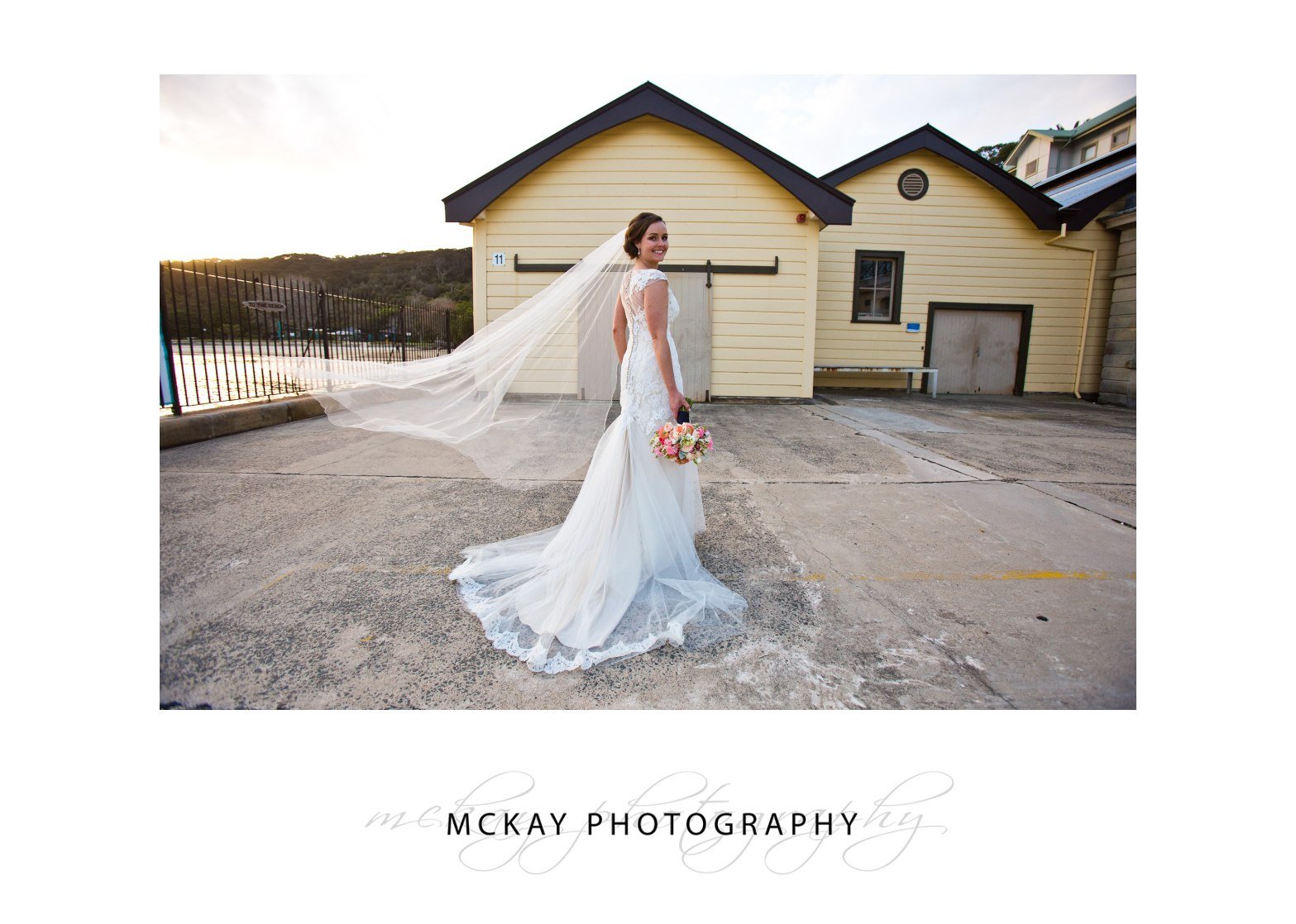 Danielle in her wedding dress and veil flying