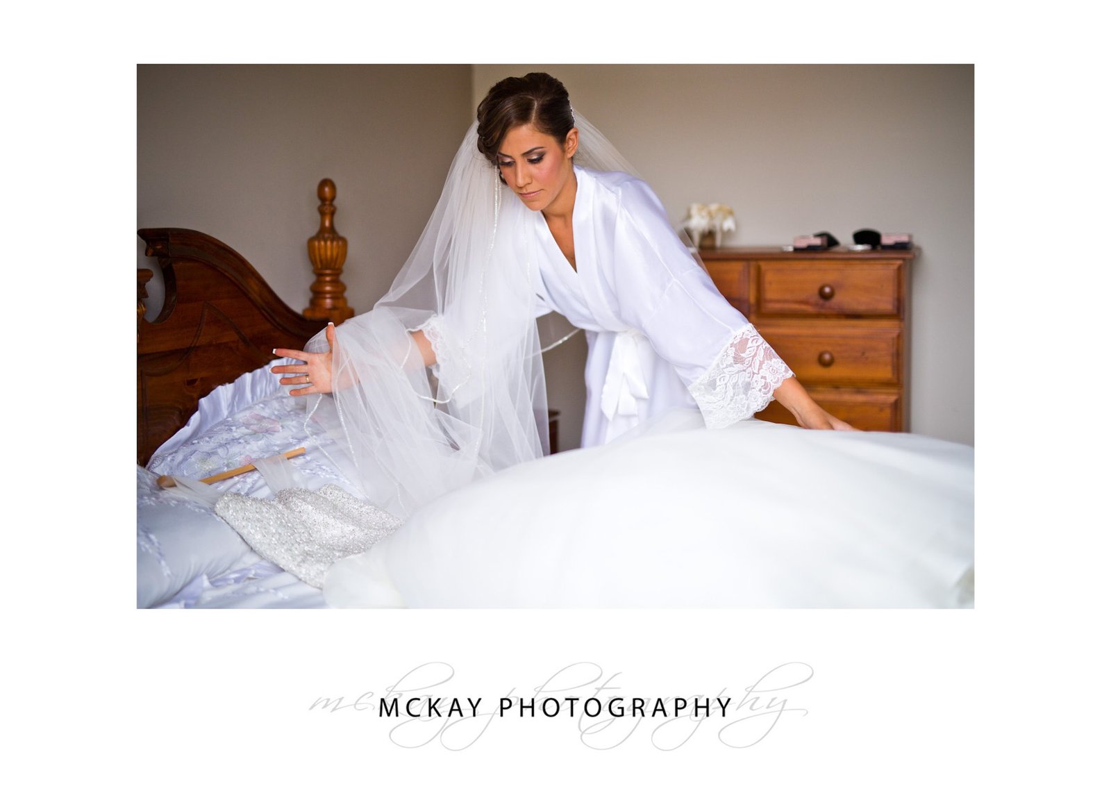 Mary lays her wedding dress on bed