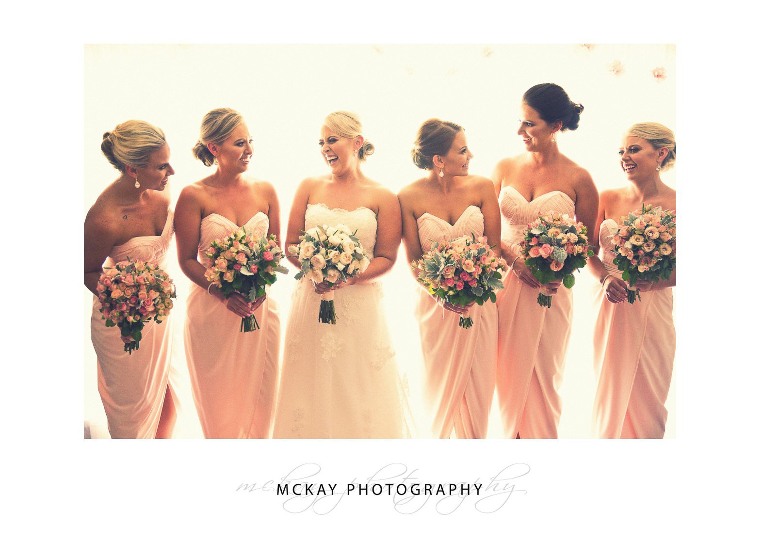 bride and bridesmaids backlit photo