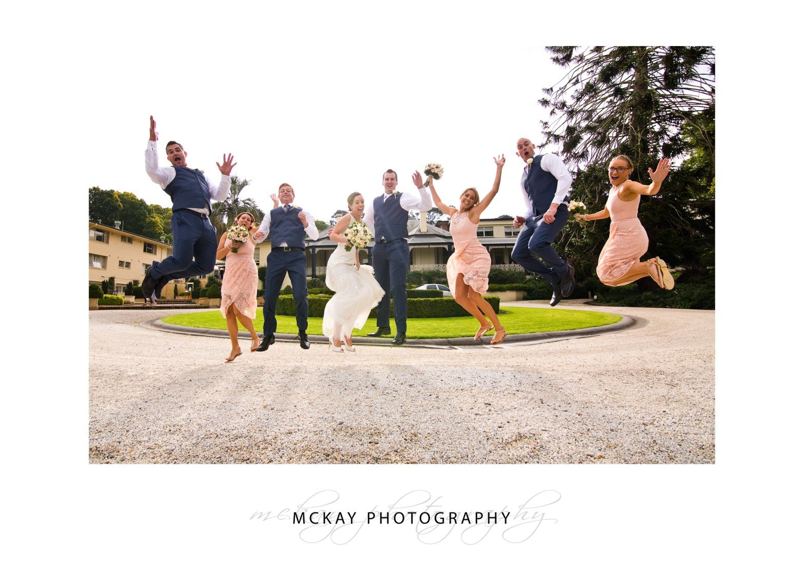 Bridal party jump photo at front of Peppers