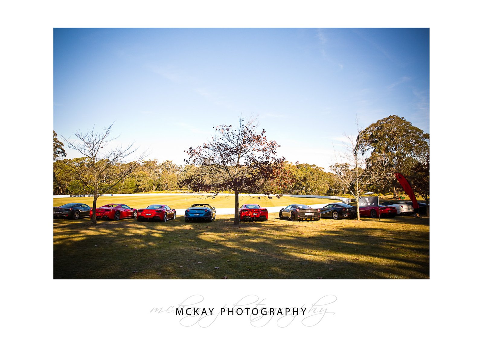 Line up of Ferrari cars at cricket oval - commercial photography Bowral