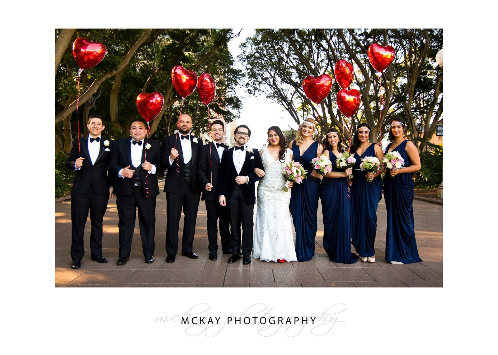 Bridal party at Hyde Park Sydney holding red love balloons