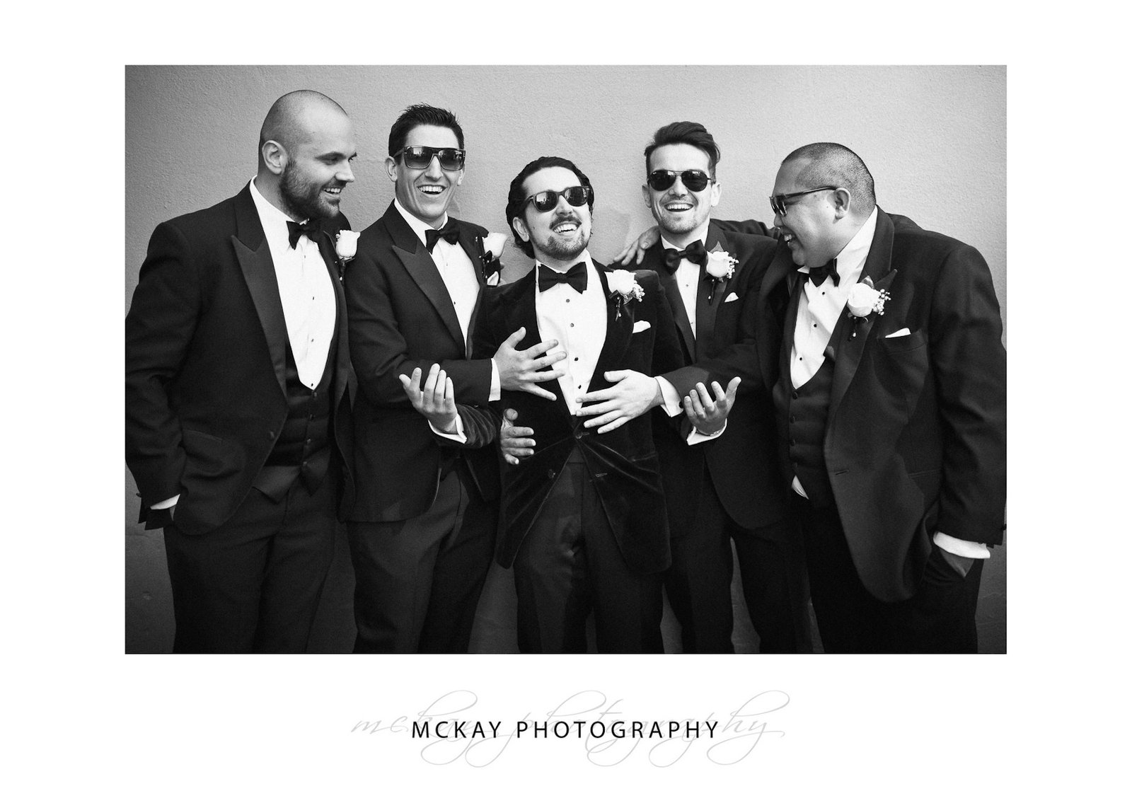 Groom and groomsmen fun candid photo black & white