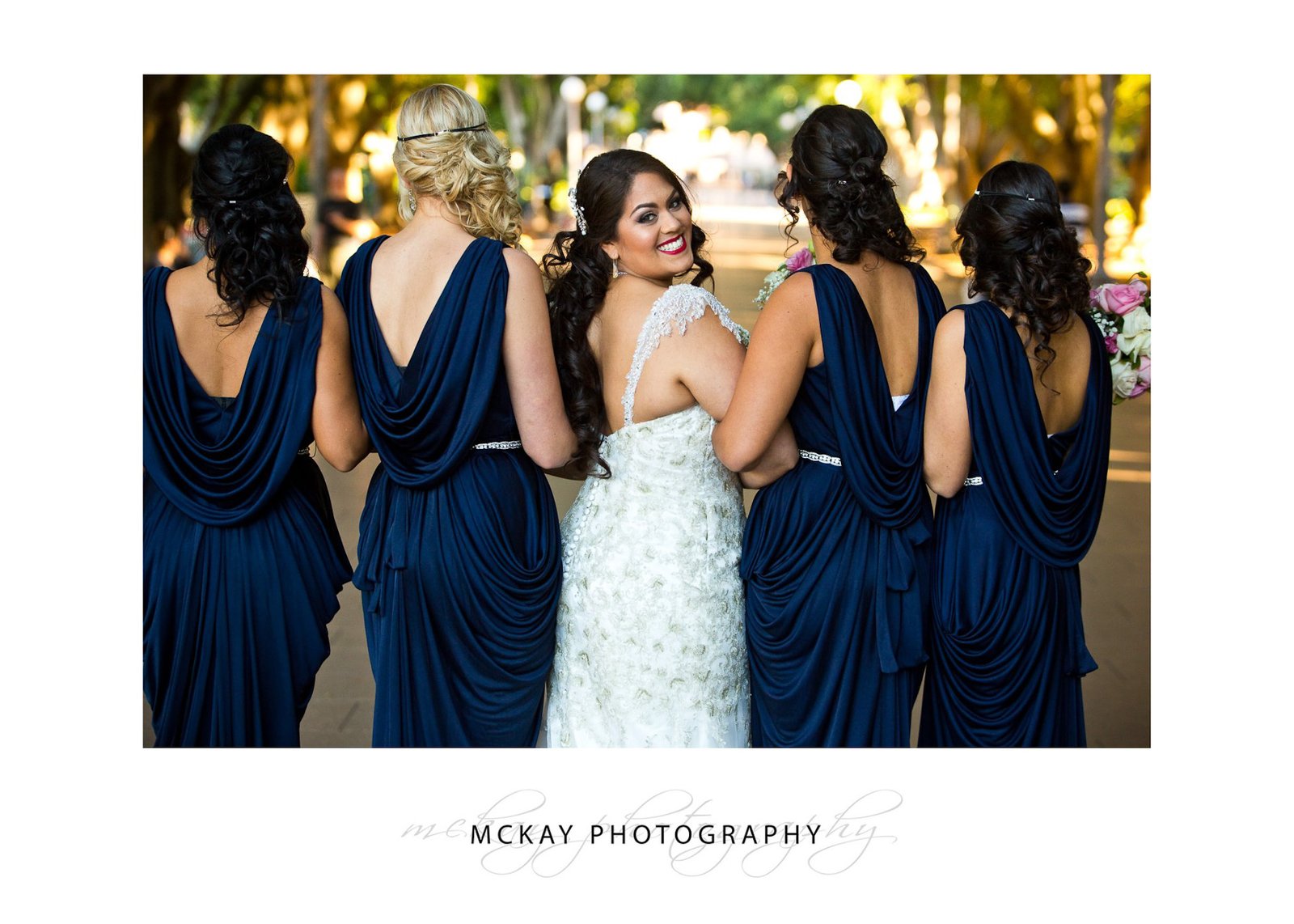 Nicole and her bridesmaids wearing blue backless dresses