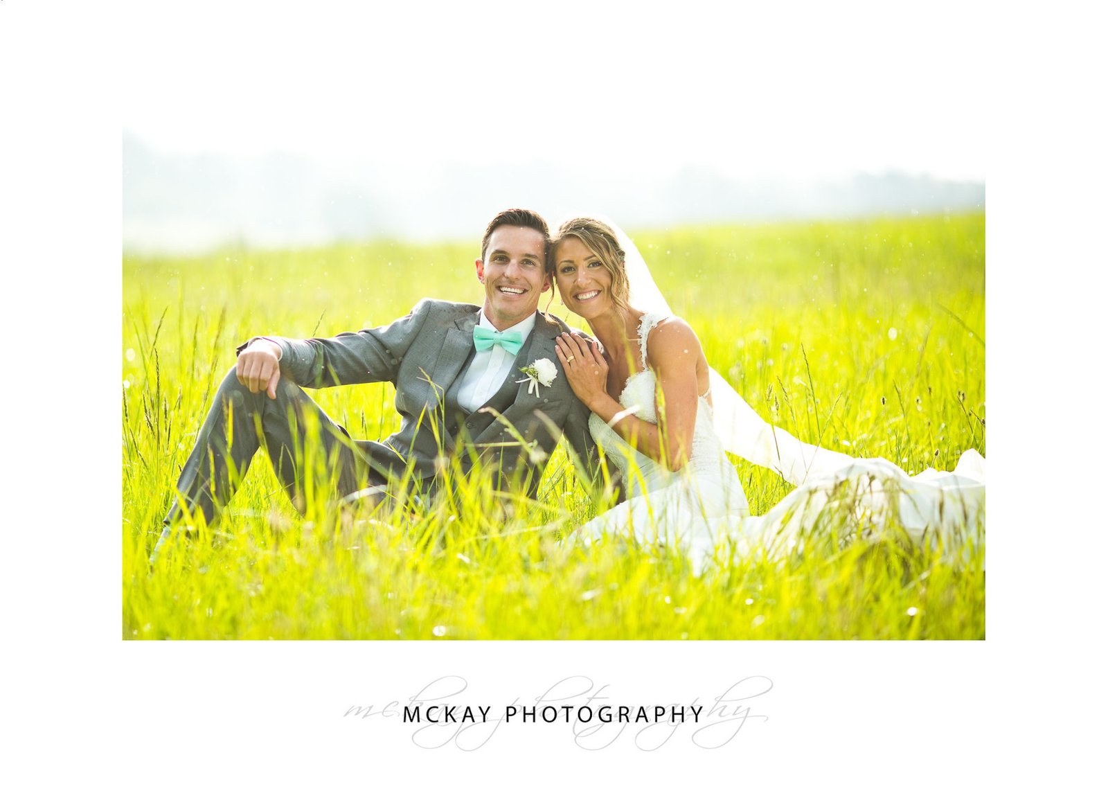 Celia & Michael in grass field near Briars Southern Highlands wedding