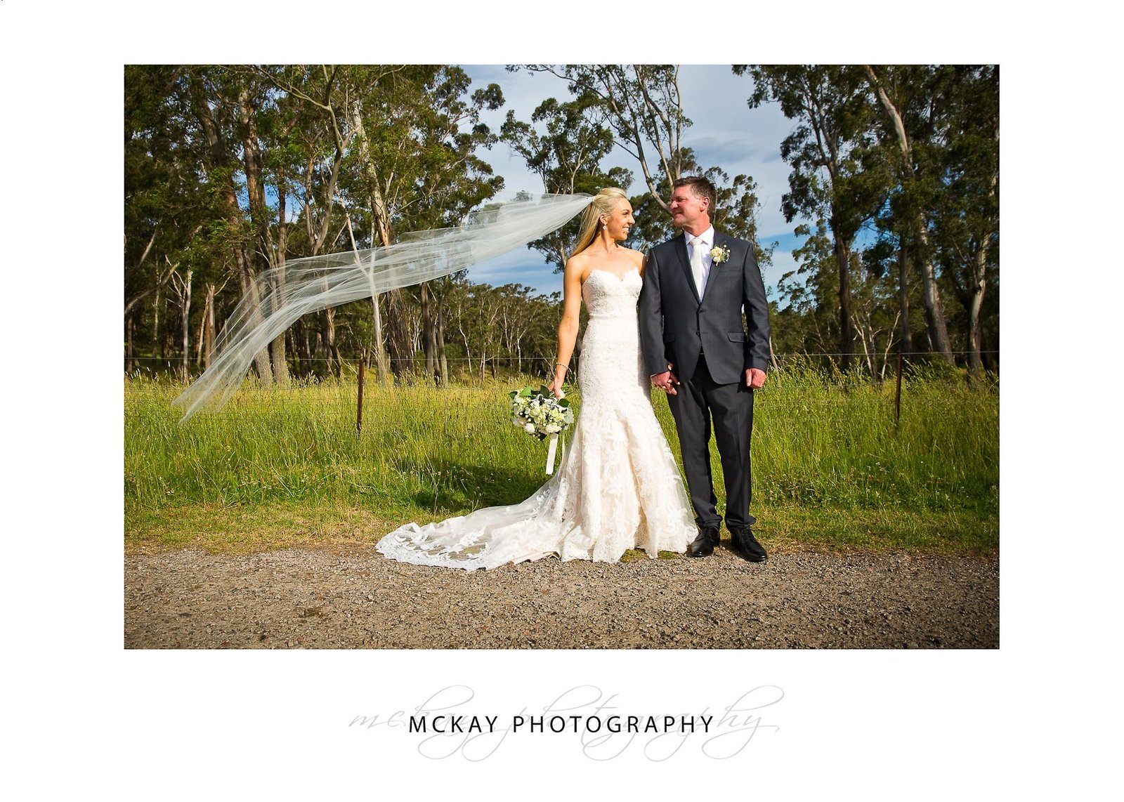 Bride and groom windy veil