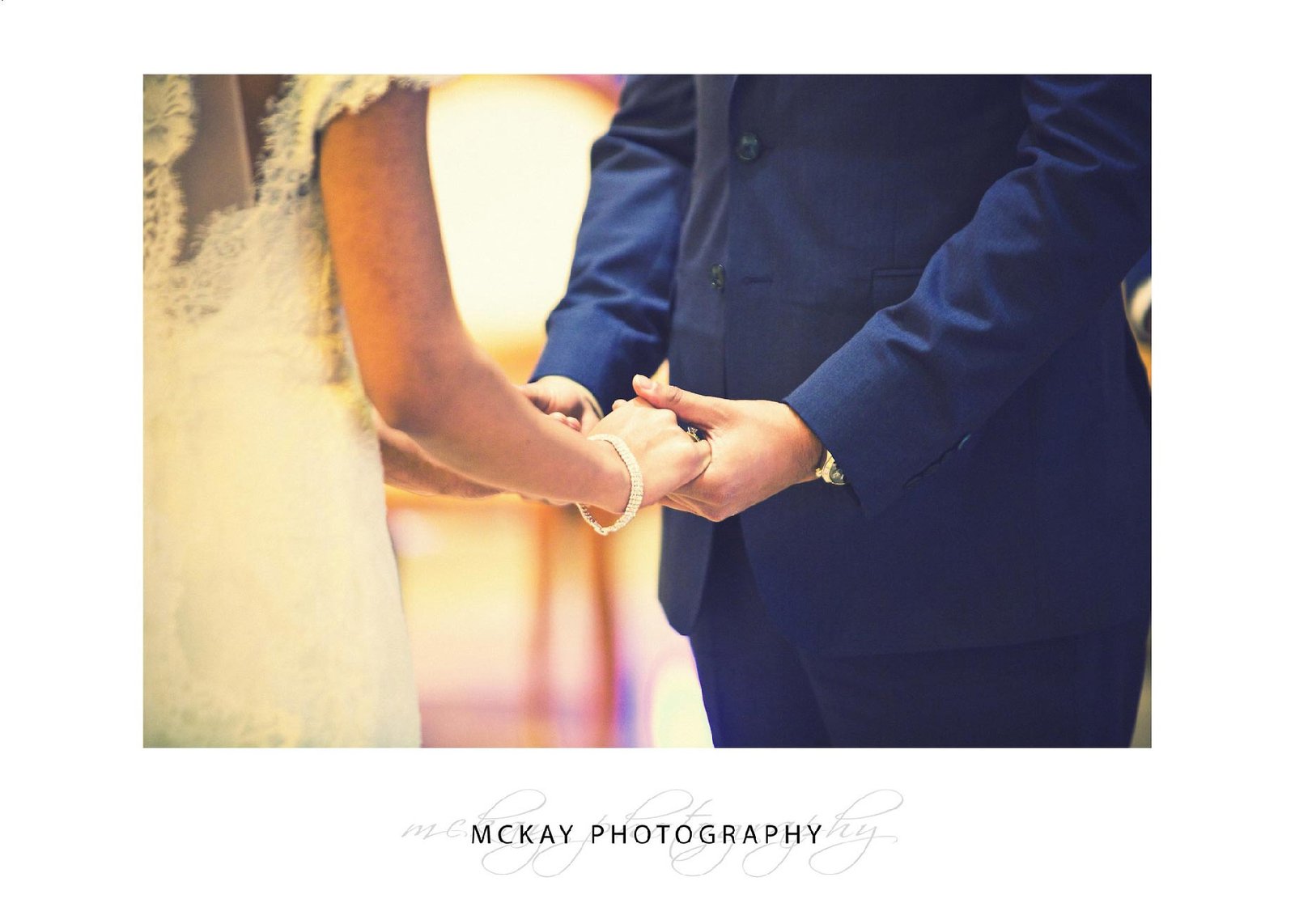 Close up holding hands during ceremony